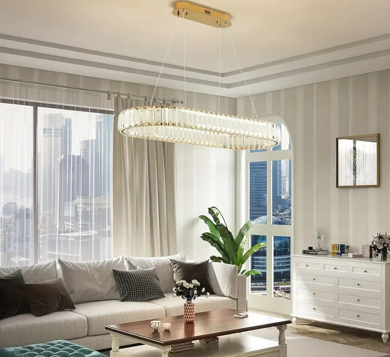 Modern living room with a chandelier, sofa, coffee table, and decorative elements.