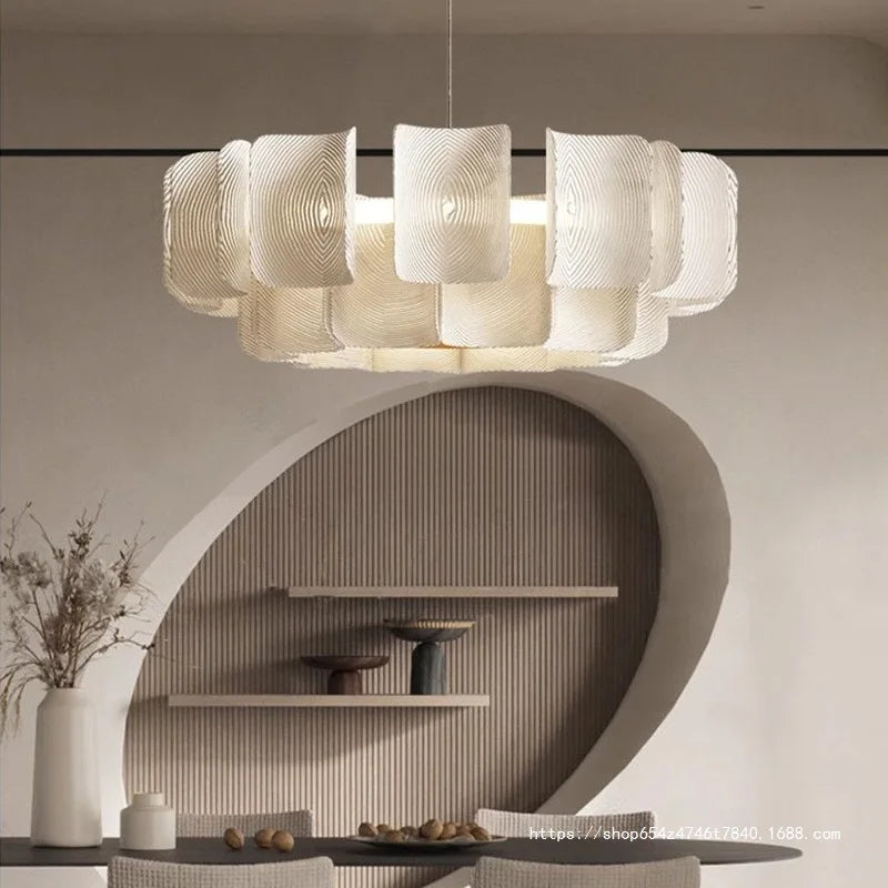 Modern chandelier hanging in a room with shelves and decor