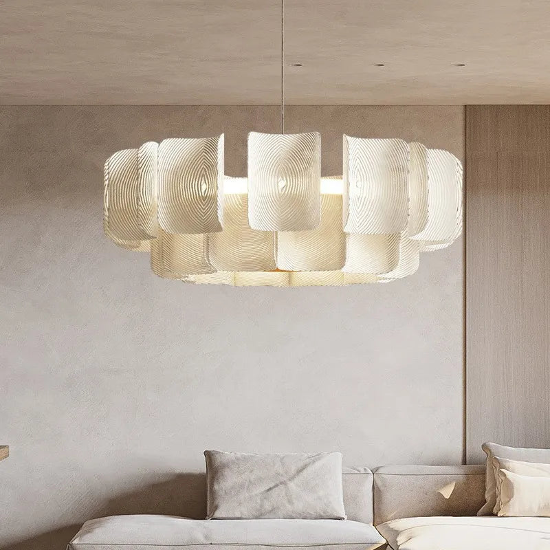 Modern chandelier hanging above a sofa in a living room setting.